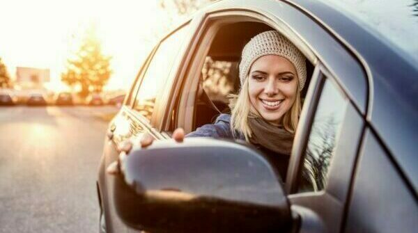 beautiful-young-blond-woman-driving-a-car-SBI-305194177-600x400