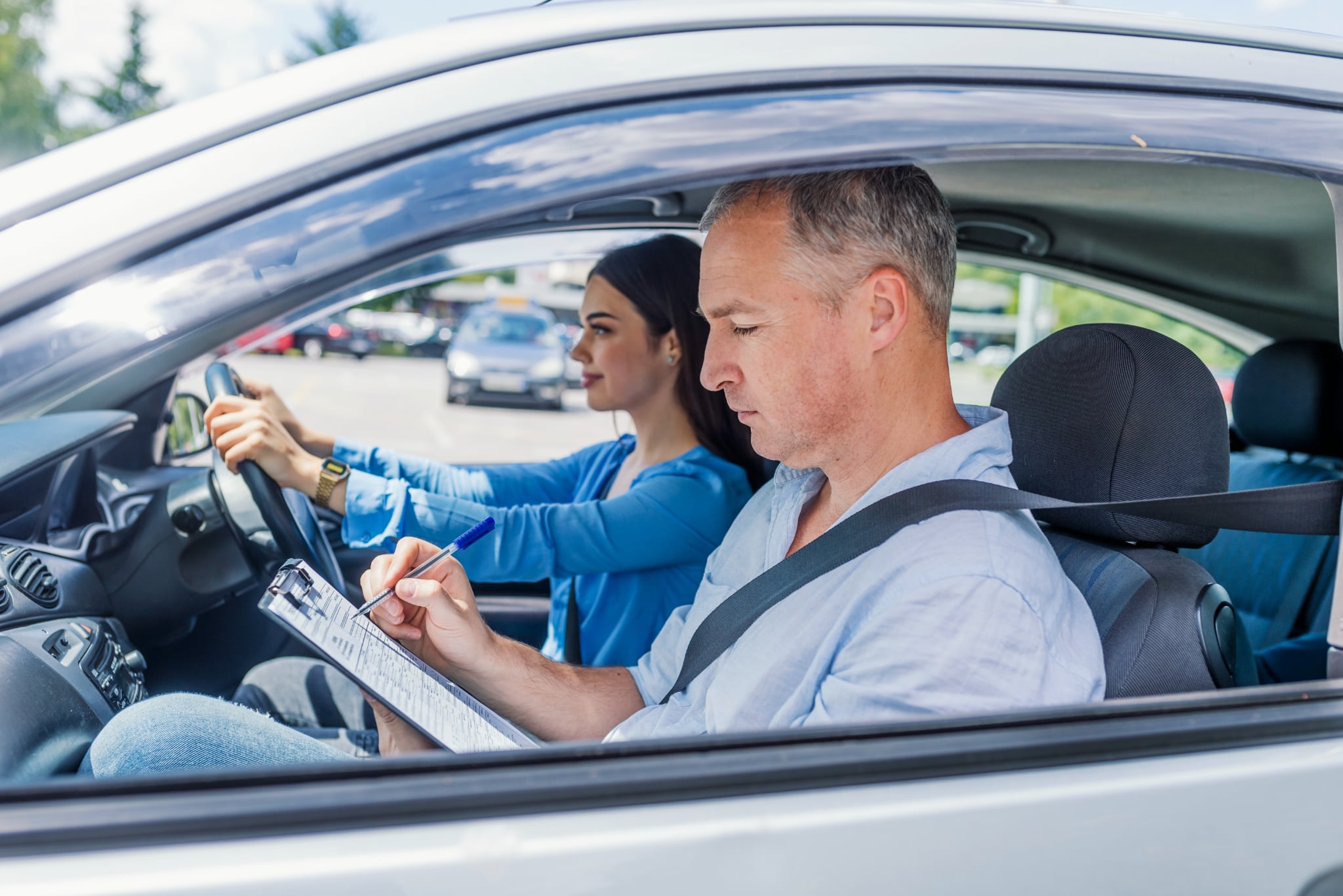 driving-instructor-woman-student-examination-car